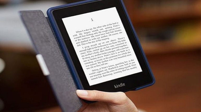 Image of a person holding E-book in his hand