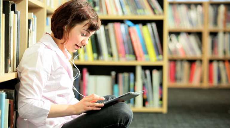 Image of a women reading book in library