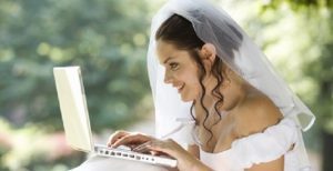 A Happy Bride holding a laptop