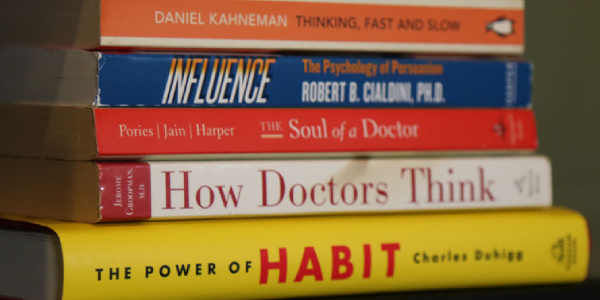 A Pile Of Books About Behavioural Science Placed On The Table.